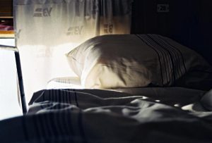A serene morning scene inside a train compartment with soft lighting and a comfortable pillow.